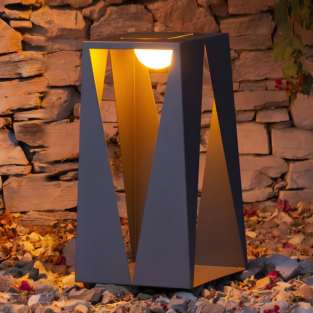 Modern lantern positioned against rustic stone wall creating dramatic lighting contrast