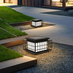 Japanese-style solar lanterns placed on stone surface creating peaceful zen garden atmosphere with natural rock elements