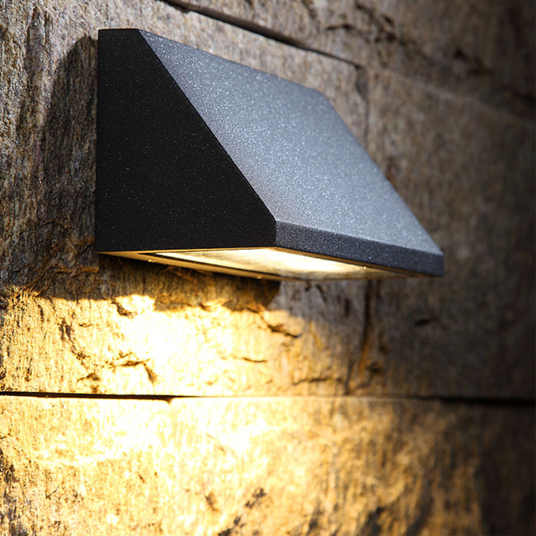 Textured brick surface with contemporary lighting creating dramatic shadows and architectural depth