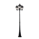 Classic black Victorian-style street lamp with three ornate lantern heads on plain background