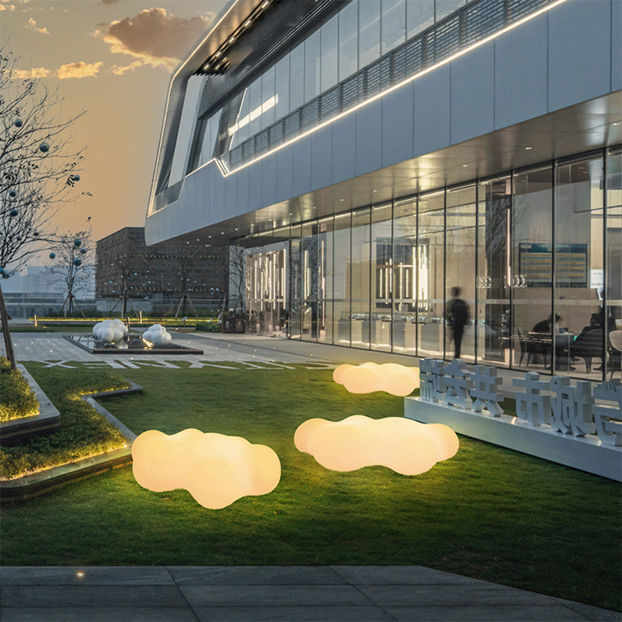 Contemporary commercial building courtyard featuring multiple illuminated cloud lights at dusk