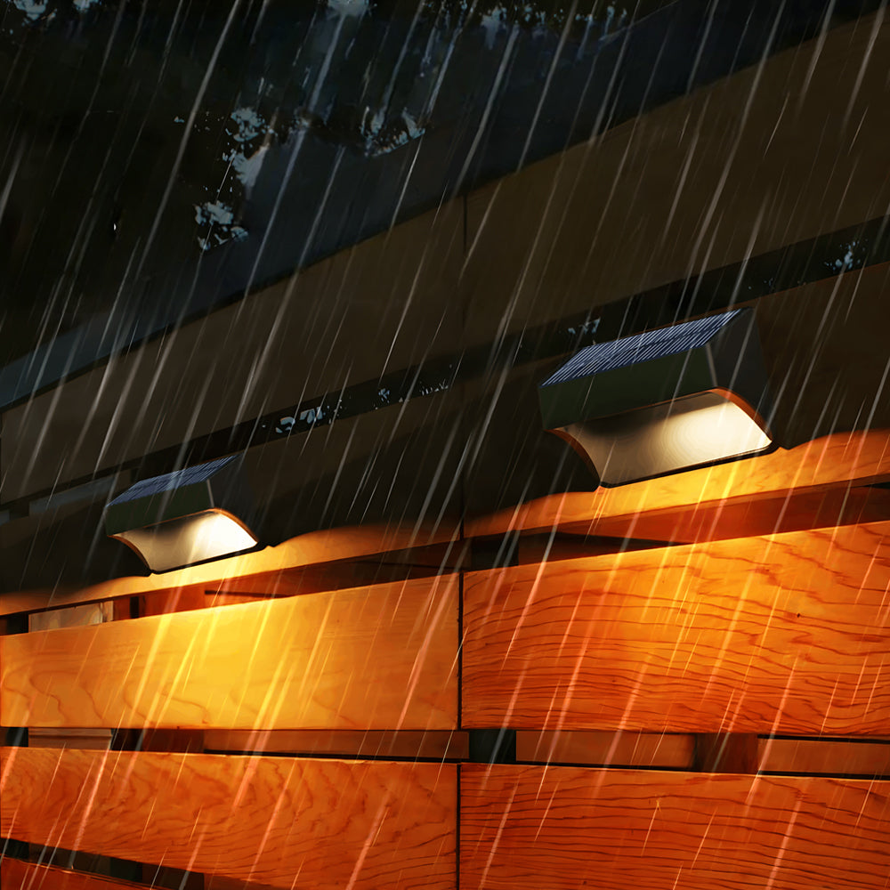 Wooden deck railing enhanced with warm LED strip lighting creating cozy outdoor ambiance during rainfall