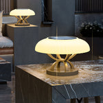 Modern circular bollard light with dome top and cylindrical base creating gentle ambient illumination for landscapes
