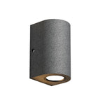 Cylindrical concrete outdoor light with textured finish creating warm downward illumination