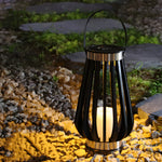 Garden pathway lantern positioned among decorative stones and natural landscaping