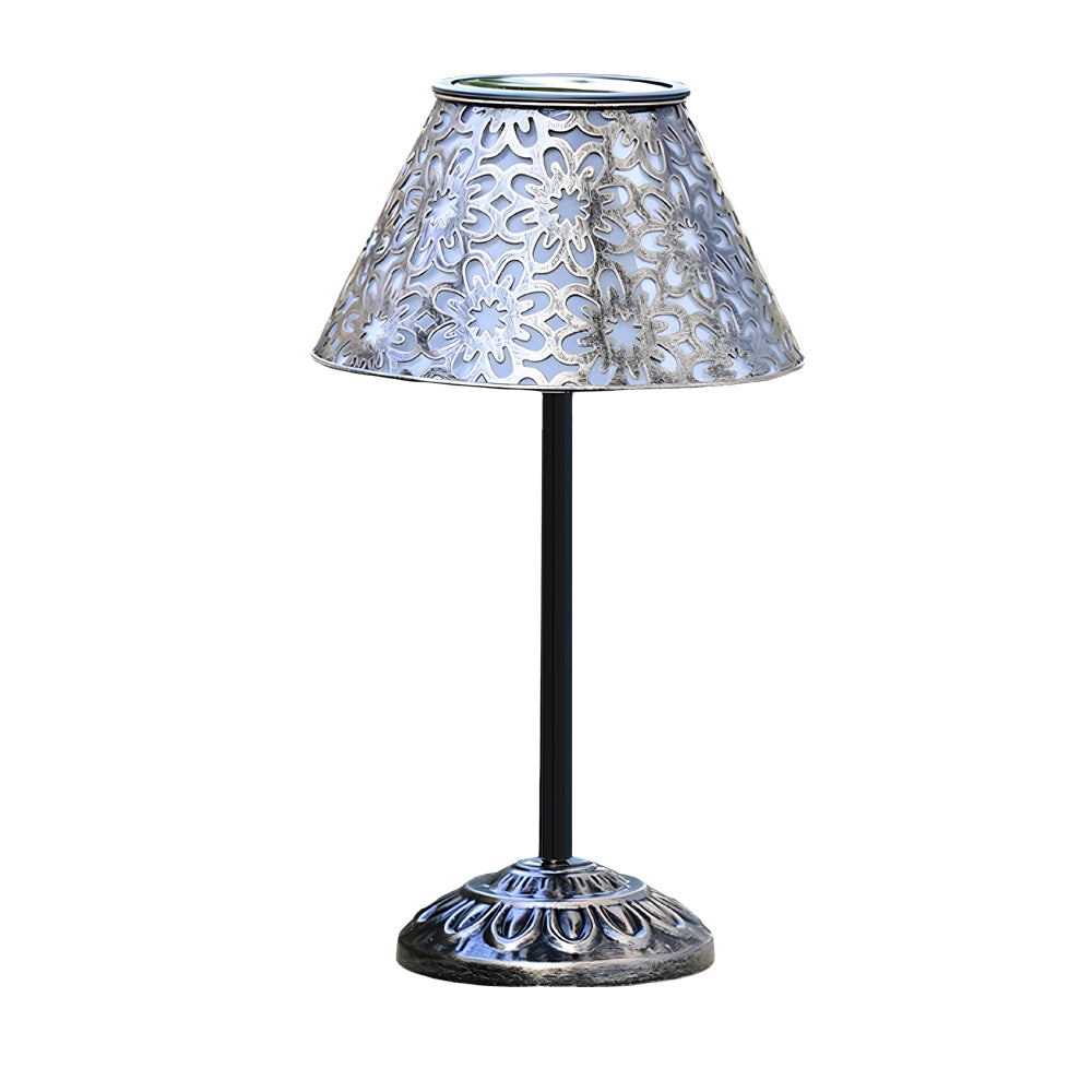 Decorative solar table lamp with intricate perforated metal shade and ornate base design