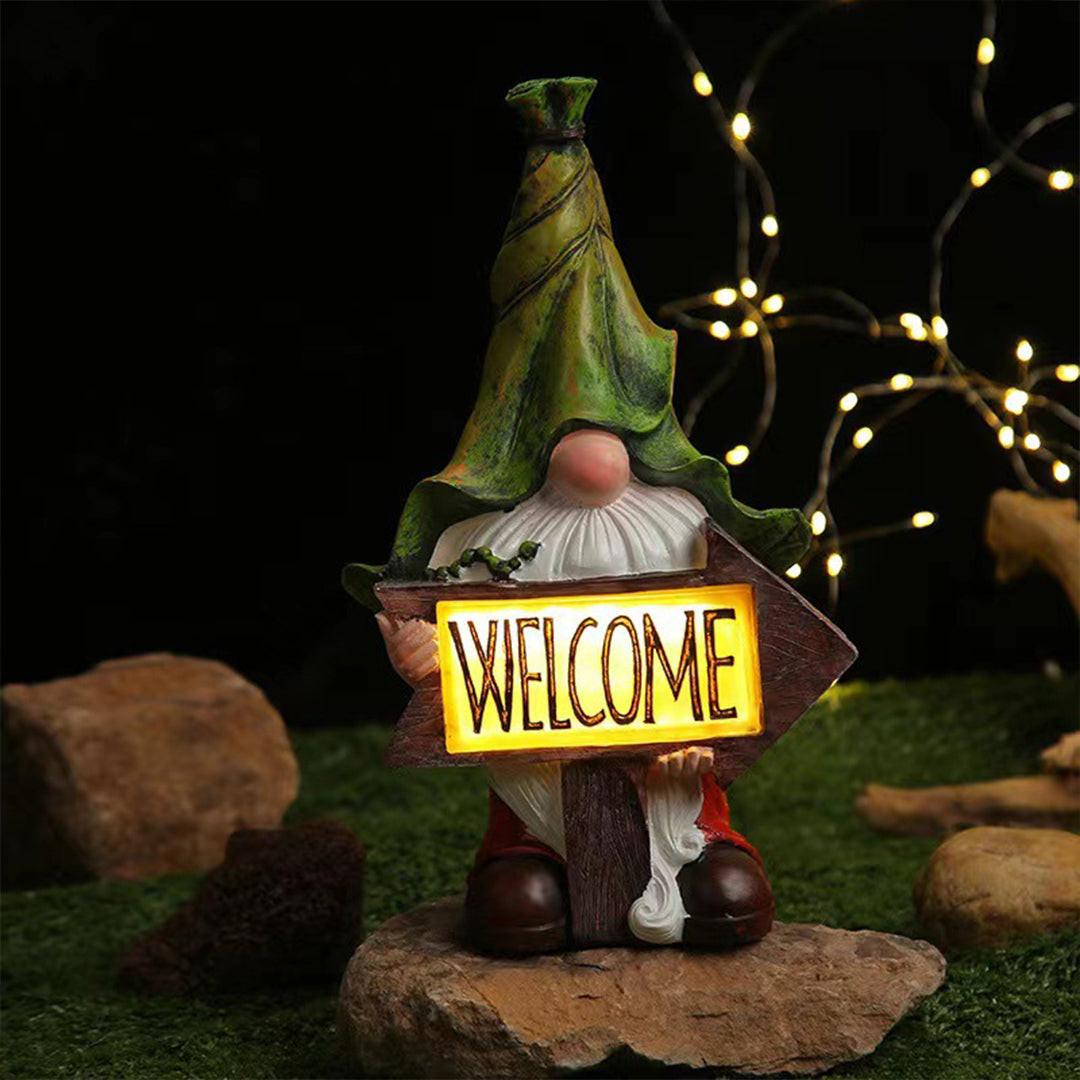 Welcome gnome with illuminated sign and warm LED lighting for evening garden ambiance