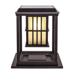 Two elegant post cap lights with vertical bar design illuminating concrete pillars at evening