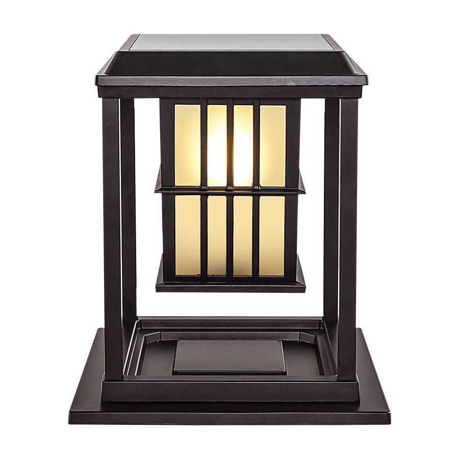 Two elegant post cap lights with vertical bar design illuminating concrete pillars at evening