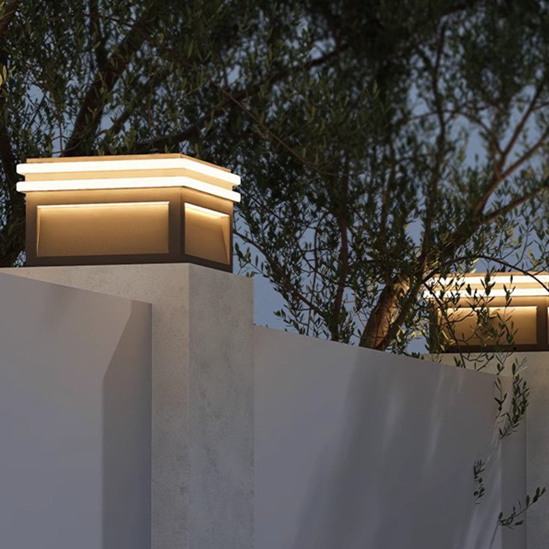 Modern cubic wall-mounted light fixtures creating dramatic architectural illumination on contemporary building facade at night