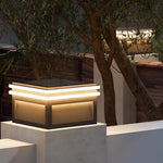 Modern cube post lights illuminating contemporary residential patio area with warm ambient lighting at evening