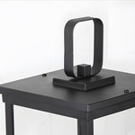 Compact LED lantern with handle positioned on outdoor table creating intimate lighting atmosphere