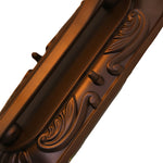 Artistic detail of decorative lantern featuring bronze leaf elements and ornate metalwork typical of classical outdoor lighting