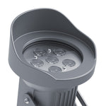 Accent lighting creating warm illumination on garden wall with dramatic shadow patterns