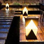 Modern angular post light with geometric V-shaped design creating dramatic upward and downward illumination