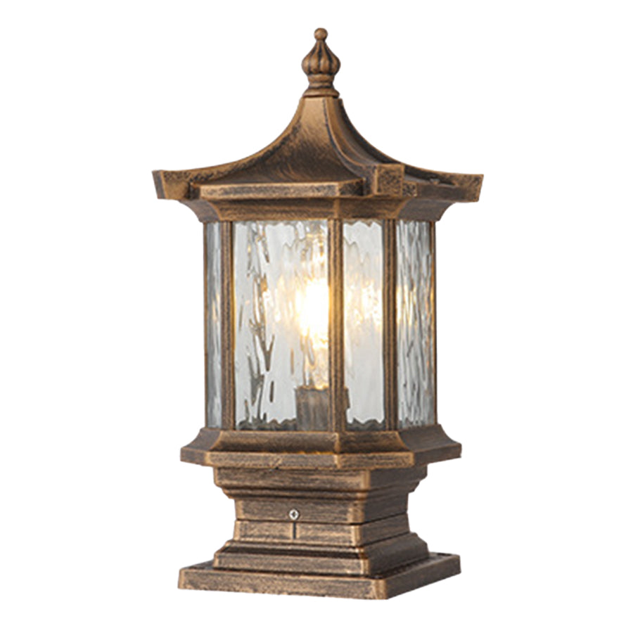 Antique bronze pillar light with textured glass panels displayed on neutral studio background