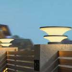Architectural post lighting installation featuring geometric stacked elements in residential garden setting at twilight