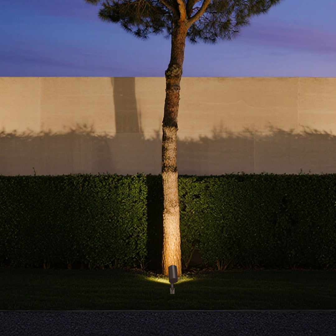 Architectural stakes for outdoor lights creating elegant tree silhouette at twilight