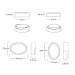 Round outdoor wall sconce with frosted diffuser creating ambient lighting on building exterior