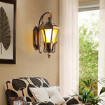 Artistic detail of decorative lantern featuring bronze leaf elements and ornate metalwork typical of classical outdoor lighting