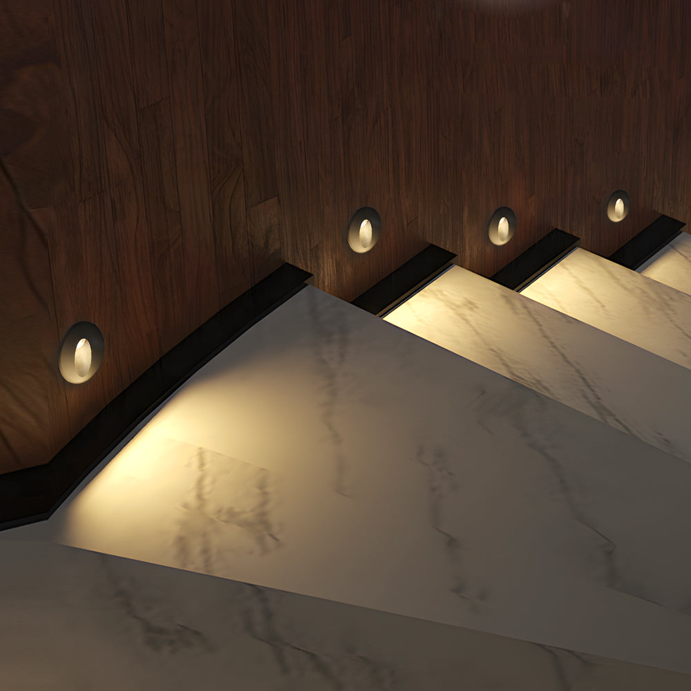 mable staircase featuring multiple recessed lights with warm ambient glow