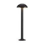 Black bollard light with dome top providing functional and aesthetic pathway illumination