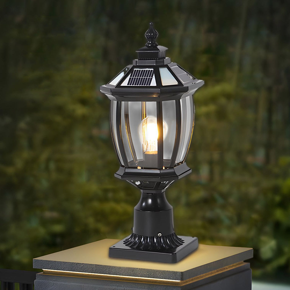 Black traditional post lantern illuminated against natural garden backdrop creating sophisticated outdoor ambiance