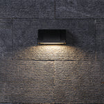 Textured brick surface with contemporary lighting creating dramatic shadows and architectural depth