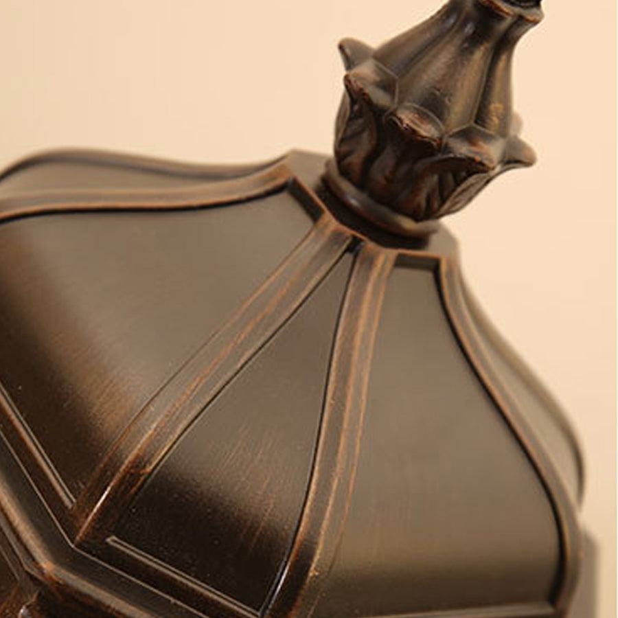 Close-up detail of bronze lamp base showing ornate decorative metalwork and craftsmanship