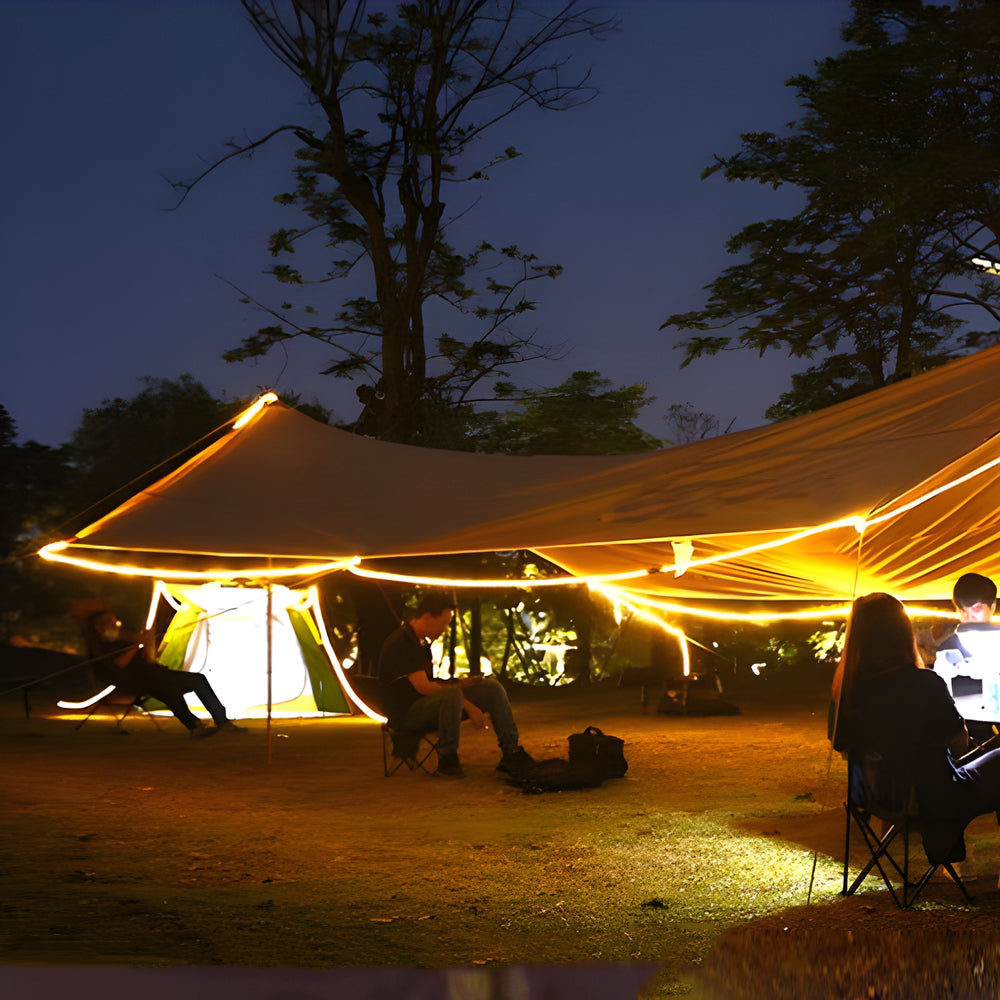 Outdoor camping setup with solar LED strips providing warm illumination for evening activities