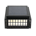 Japanese-style solar lanterns placed on stone surface creating peaceful zen garden atmosphere with natural rock elements