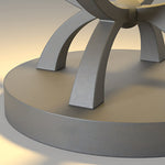 Circular concrete light fixture with curved design elements casting warm glow on modern architectural surface