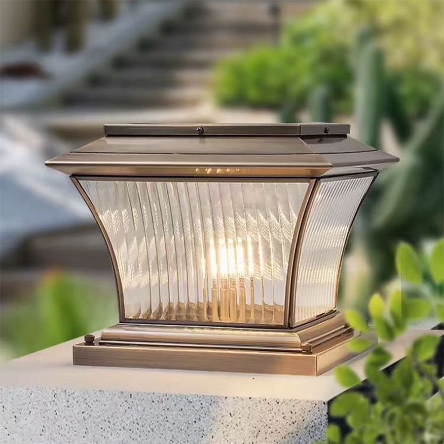 Classic pillar lantern with ribbed glass panels and antique bronze finish on white background