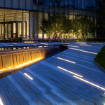 Contemporary outdoor deck with integrated LED strip lighting in wooden flooring creating modern architectural ambiance