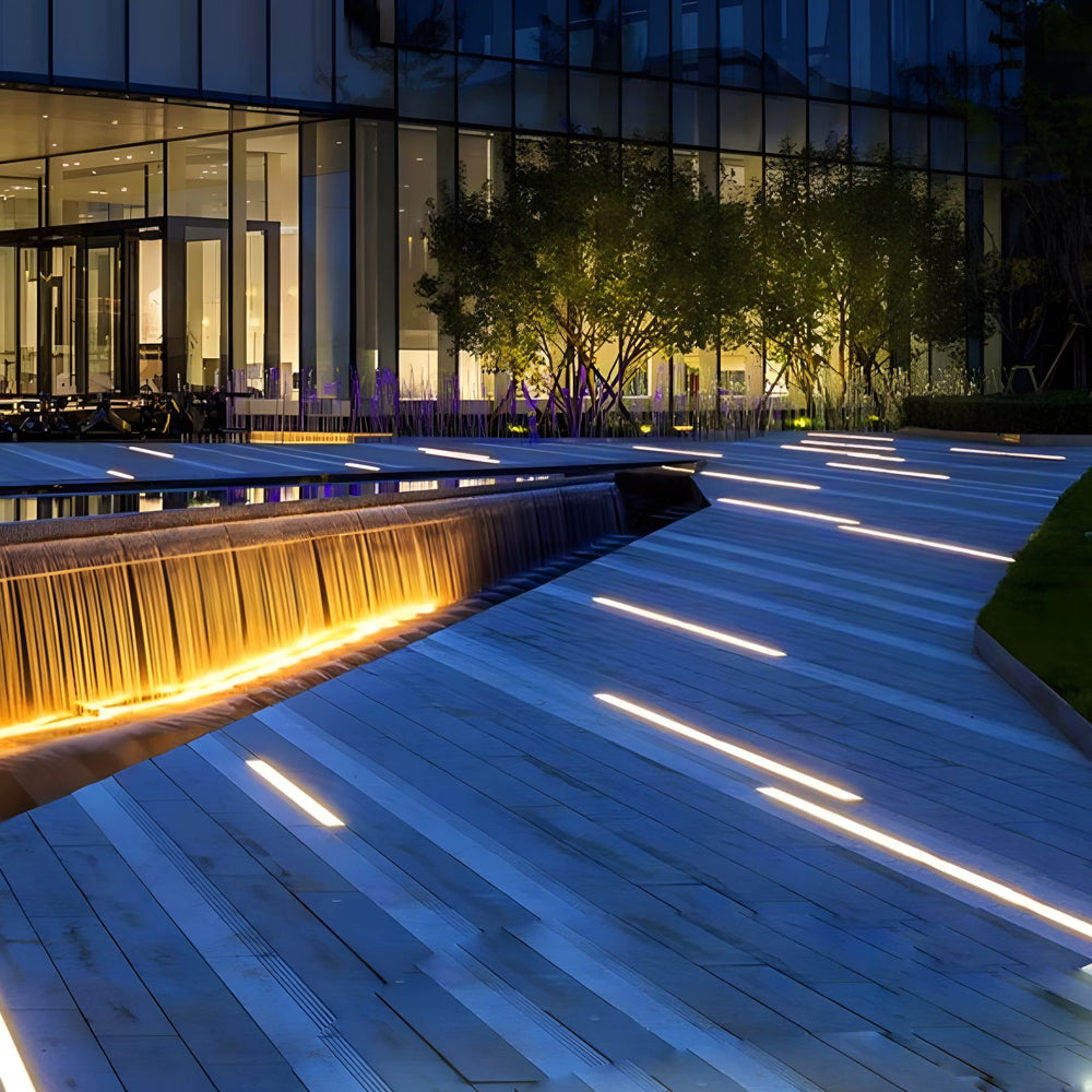 Contemporary outdoor deck with integrated LED strip lighting in wooden flooring creating modern architectural ambiance