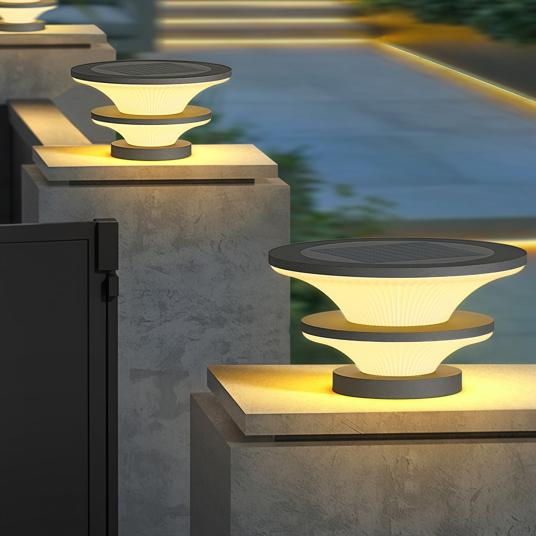 Multiple contemporary post lights installed on concrete barriers creating evening pathway illumination