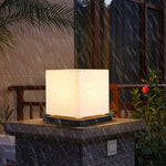 Soft cube LED light creating cozy atmosphere on wicker outdoor seating with lush greenery background