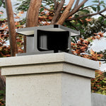 Multiple cube-shaped post lights creating sophisticated evening lighting along stone steps and pathways