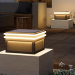 Modern cubic wall-mounted light fixtures creating dramatic architectural illumination on contemporary building facade at night
