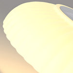 Curved LED light element with soft yellow glow demonstrating modern lighting technology for outdoor installations