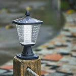 Elegant post cap light installed on stone pillar creating ambient outdoor illumination