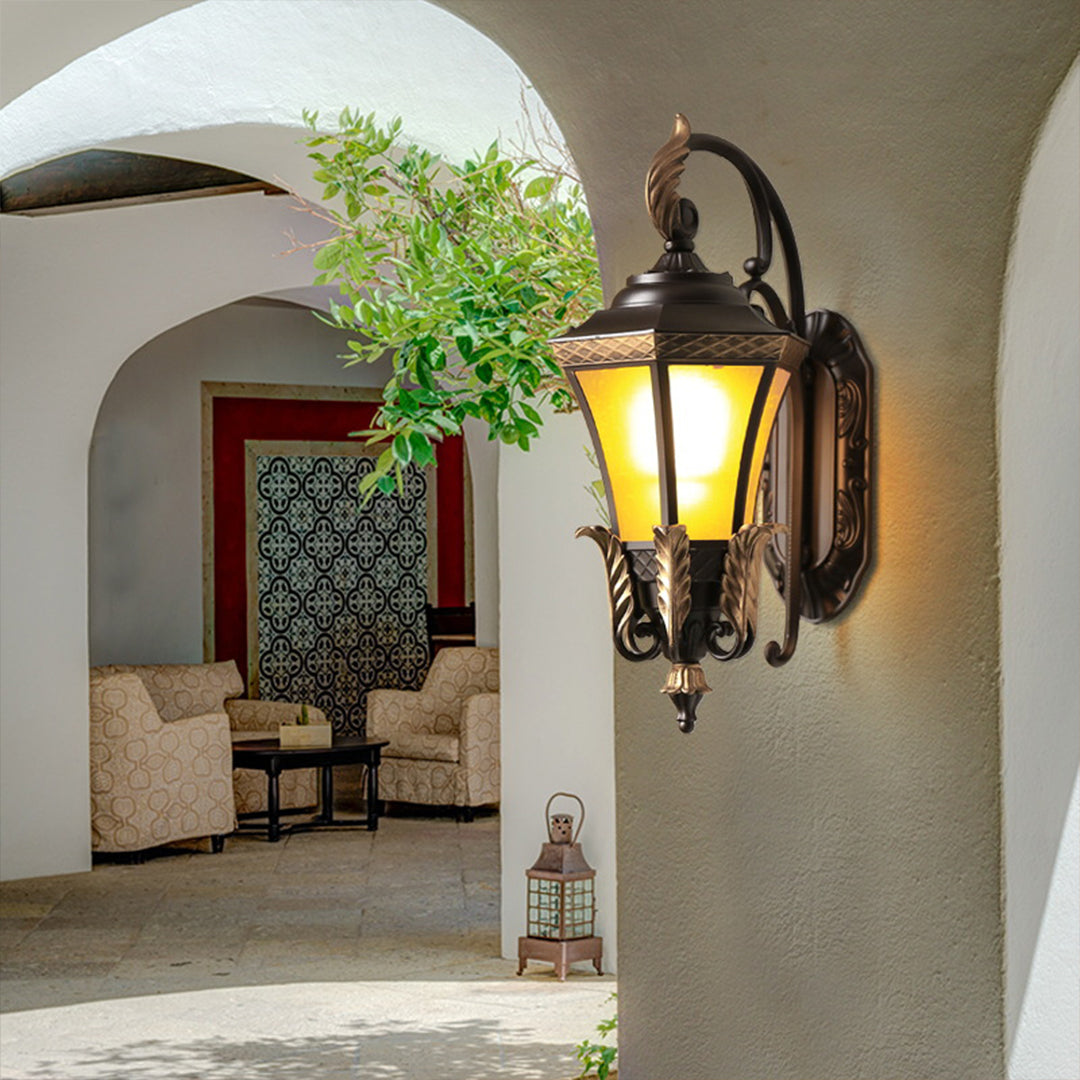Artistic detail of decorative lantern featuring bronze leaf elements and ornate metalwork typical of classical outdoor lighting