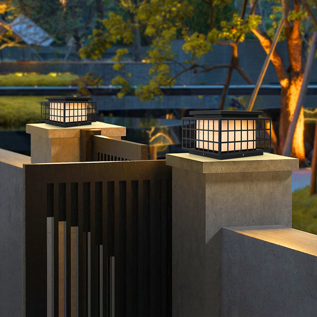 Japanese-style solar lanterns placed on stone surface creating peaceful zen garden atmosphere with natural rock elements