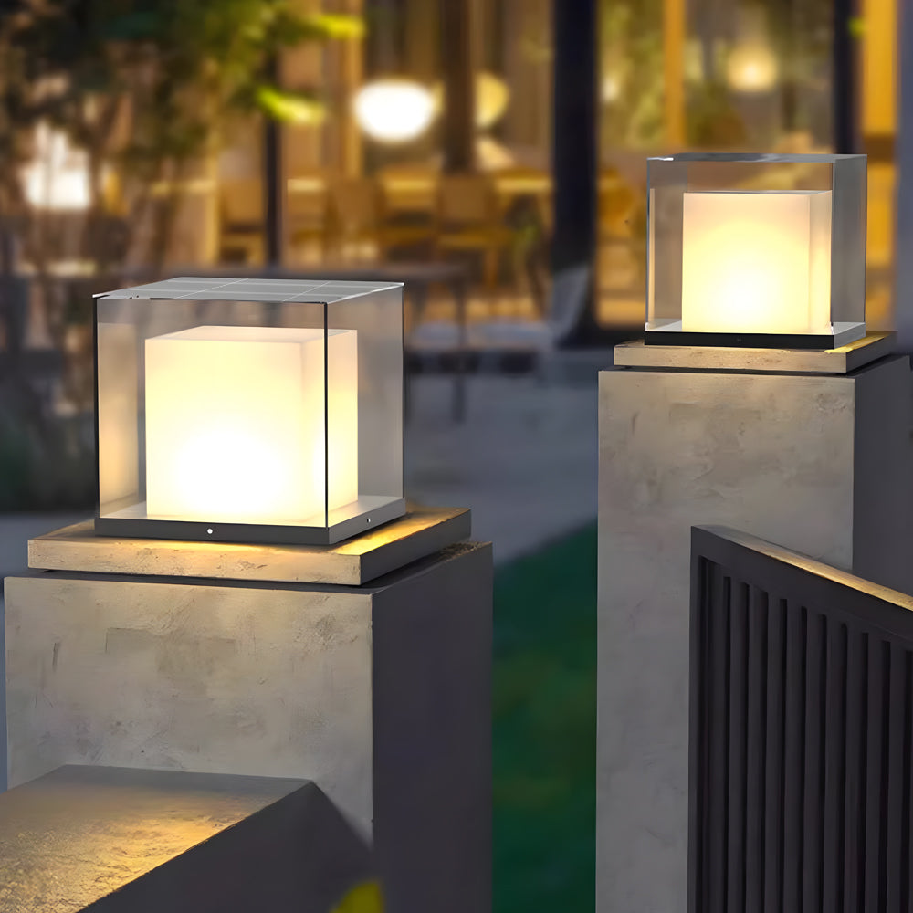 Outdoor dining area enhanced by warm glowing cube post cap lights