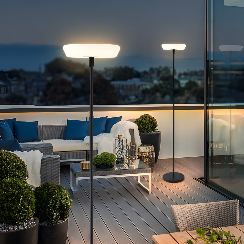 Modern outdoor terrace with floor lamps at dusk