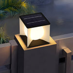 Evening patio scene with illuminated solar cube light positioned on modern railing