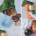Gnome holding illuminated blue flower with monarch butterfly creating enchanting garden scene