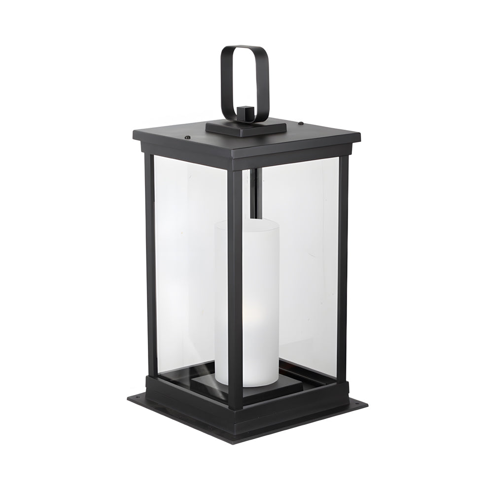 Black metal lantern with white candle pillar and handle displayed against clean white background