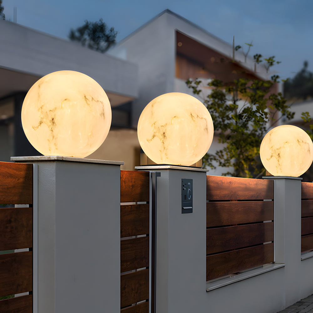 Contemporary fence design featuring multiple moon globe lights mounted on posts