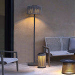 Stylish floor lamp with warm LED lighting enhancing cozy indoor seating area with textured furnishings